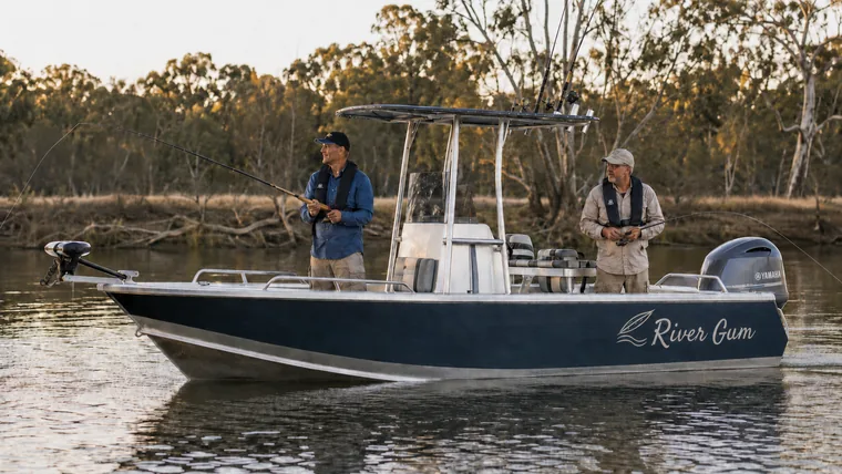 Two mates fishing from a recreational boat on an Australian river